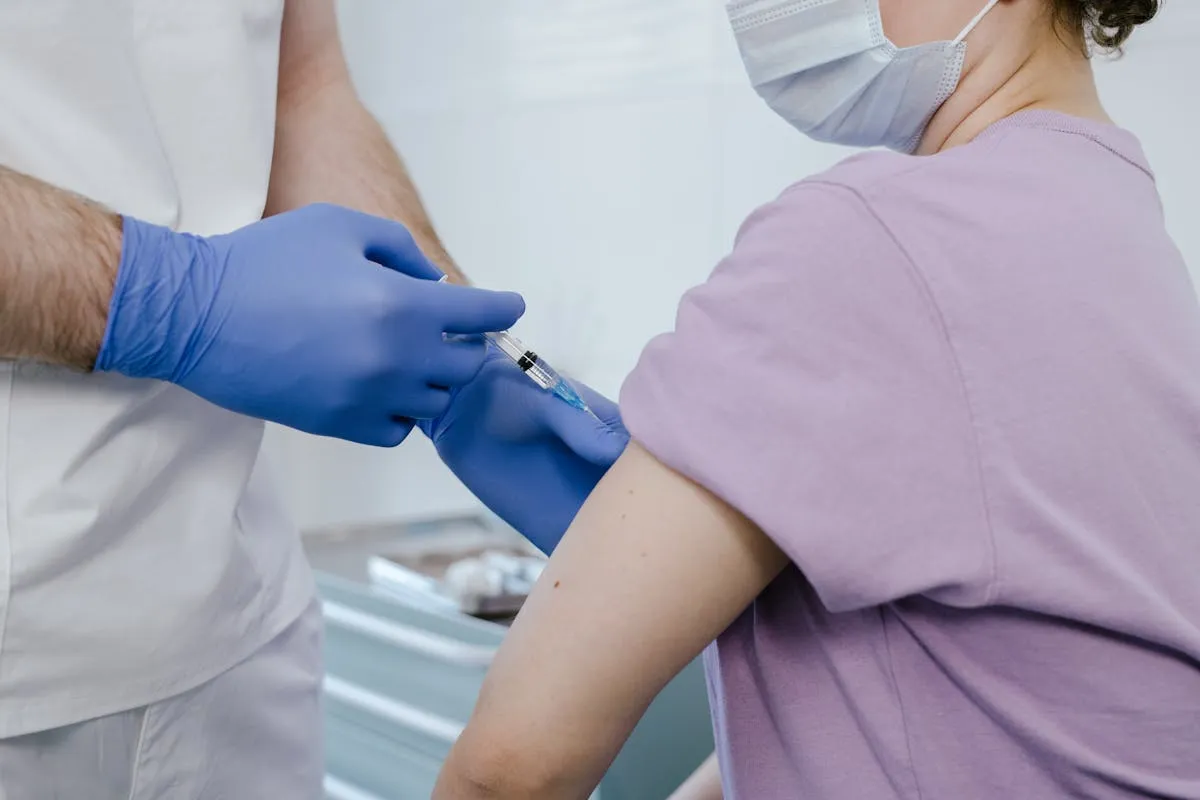 Close-up of a healthcare worker giving a vaccine injection to a patient.